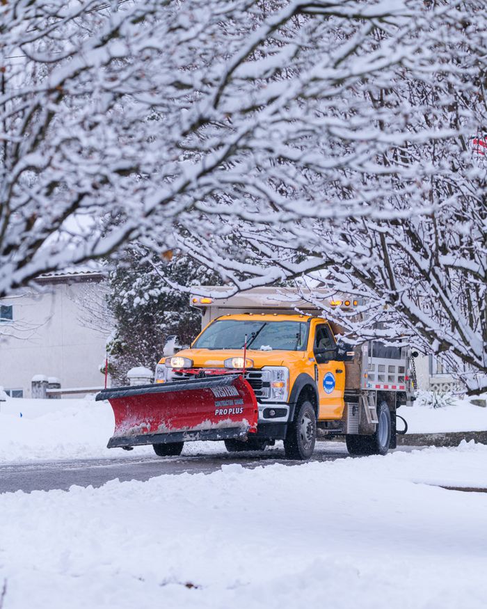 Our Services A snow plow clears a snowy residential street in Canonsburg, Pennsylvania during winter.